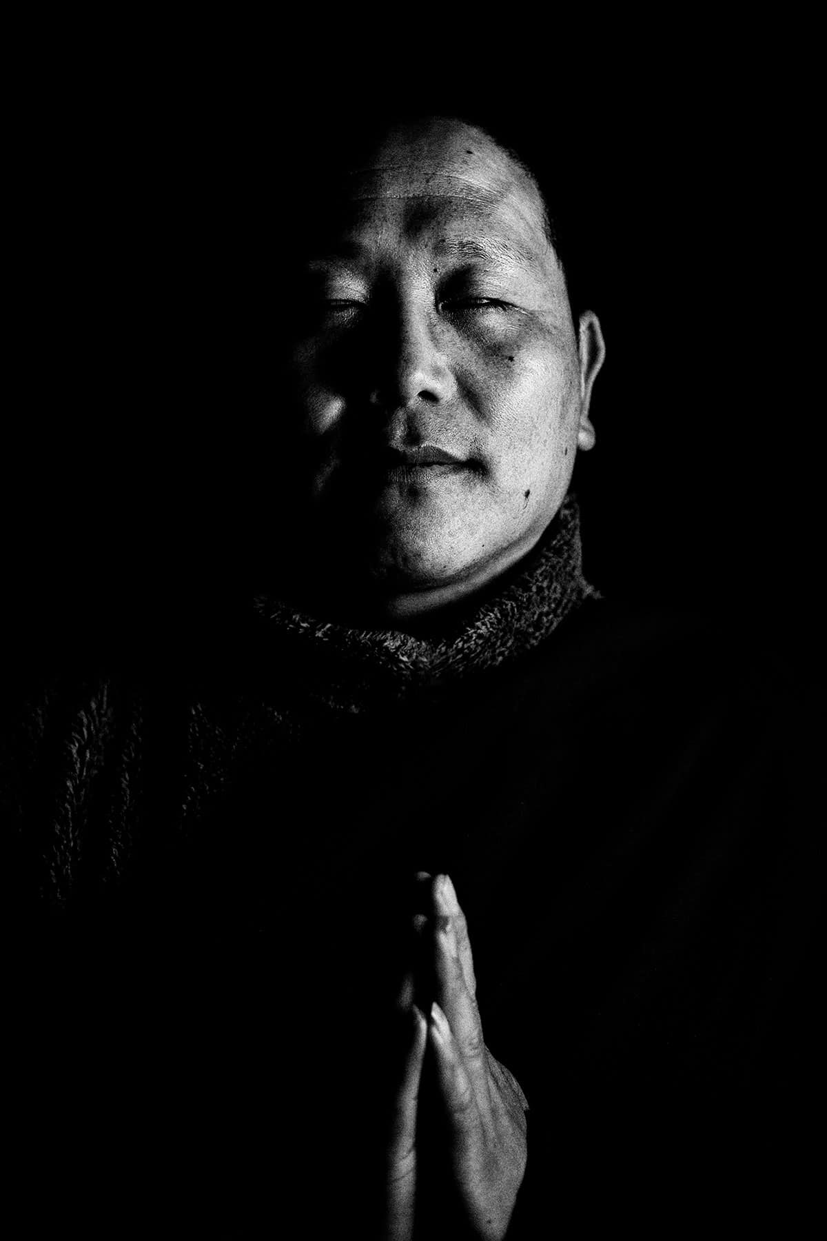 Eyes Closed Portrait of a Bhutanese Monk: Black and White Portrait Photography by Jean Tran and Élysée Lang