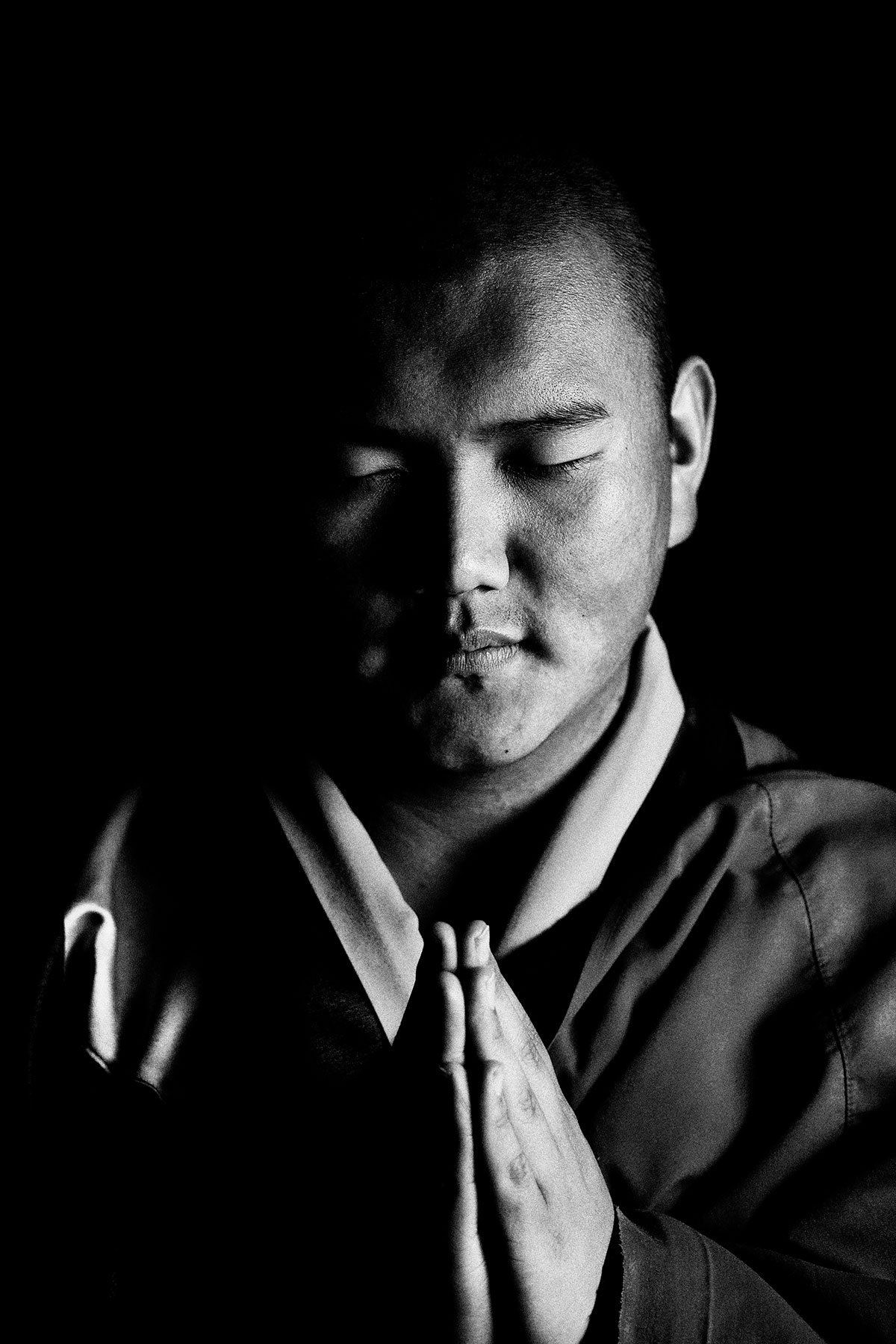 Eyes Closed Portrait of a Bhutanese Monk: Black and White Portrait Photography by Jean Tran and Élysée Lang