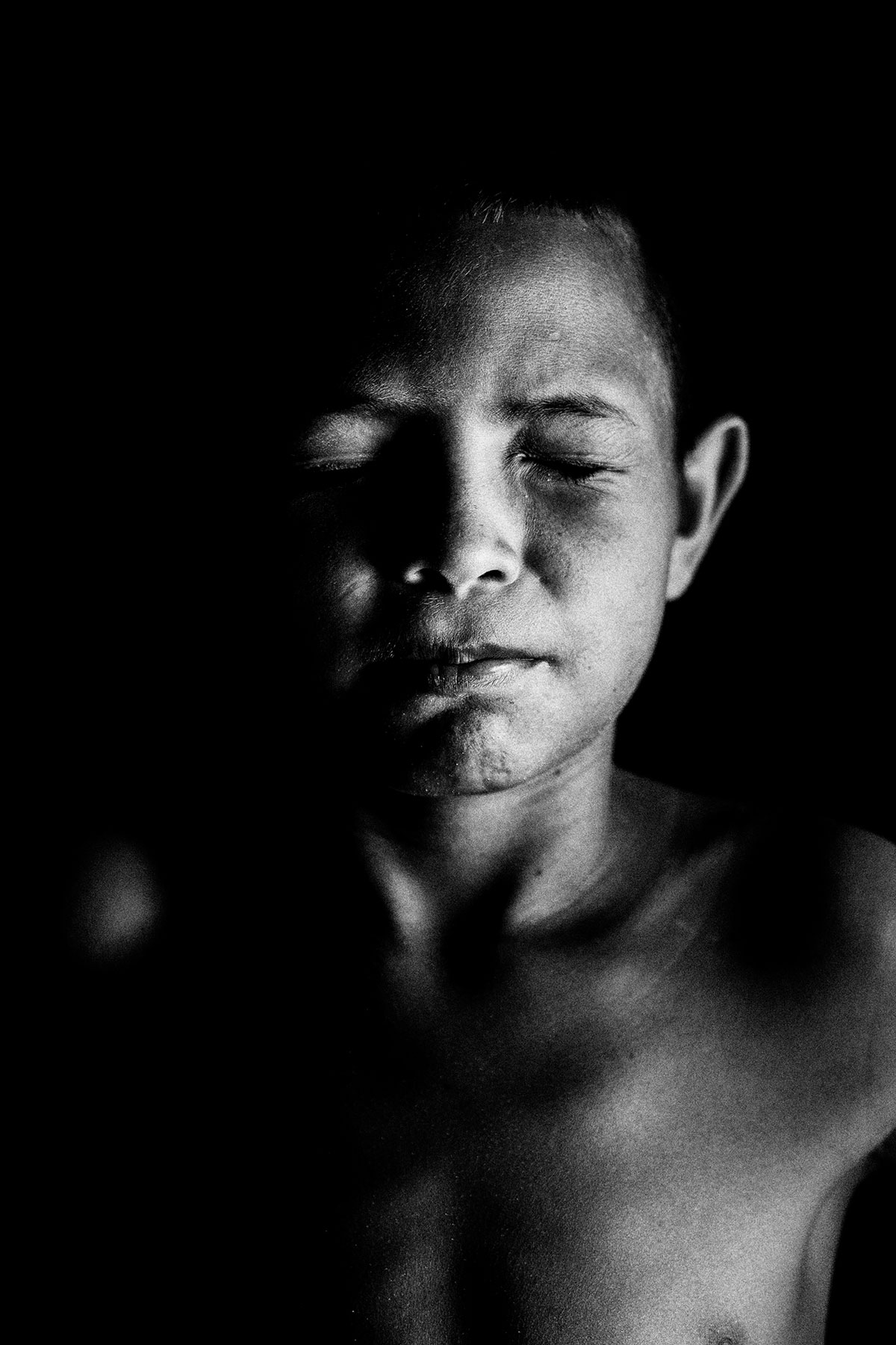 Eyes Closed Portrait of a Child from Ilha dos Lençóis: Black and White Portrait Photography by Jean Tran and Élysée Lang